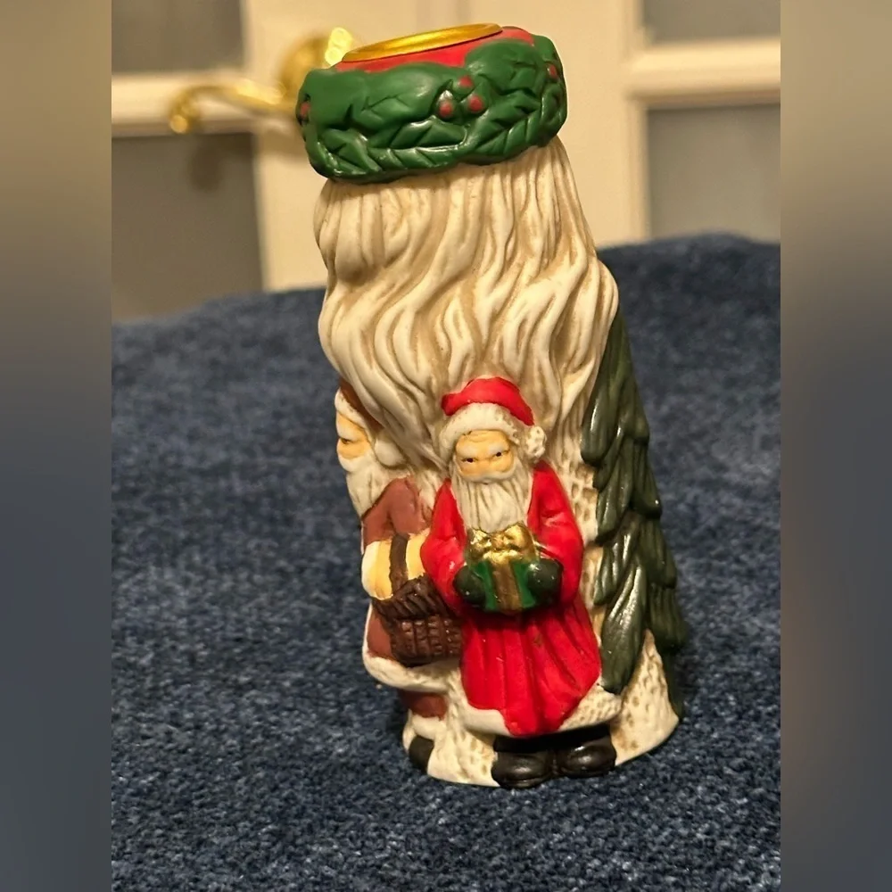 Set of 2 Santa candleholders. Each has smaller different smaller Santas.